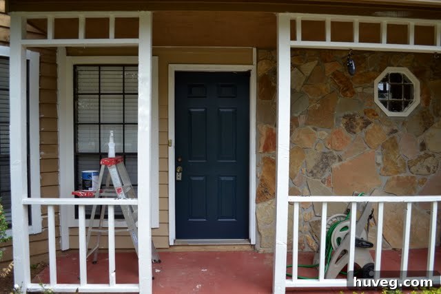 In-progress painting of a front stoop, showing a partially refreshed surface with new paint.
