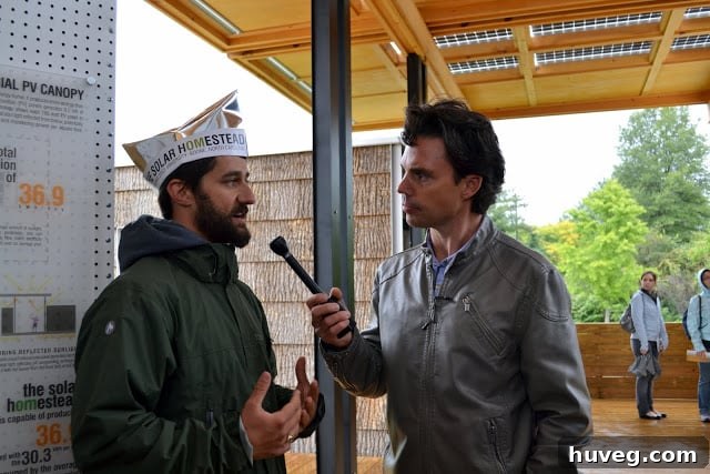 Brooks Utley interviewing a representative in front of the Appalachian State University solar house