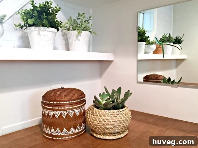 Closeup of the right side of the laundry room near the mirror, showing decorative storage.