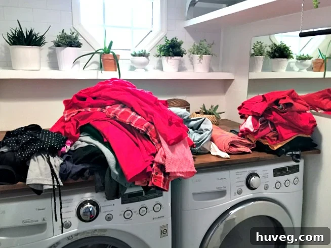 A load of red laundry in the washing machine.