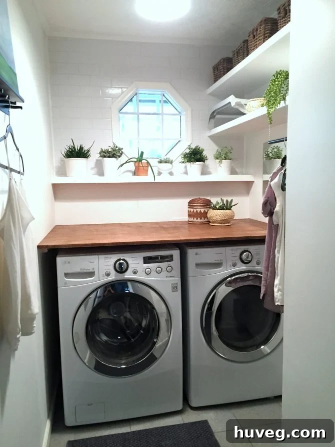 The newly finished laundry room with shelves, hanging rod, and organized counter space.