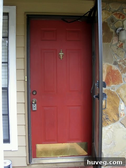 Close-up of old red door and broken storm door