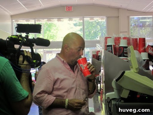 Andrew Zimmern, host of 'Bizarre Foods,' eating at The Varsity restaurant, captured unexpectedly during a college gameday.