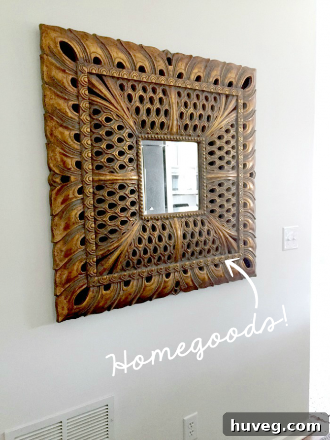 Close-up of the elegant square peacock mirror from Homegoods