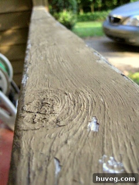 Close-up of old wooden trim being prepped with caulk for renovation.