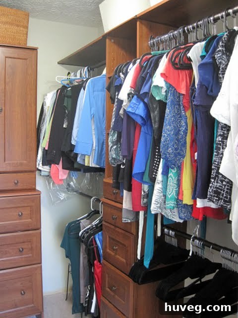 Neatly organized closet with clothes on matching hangers.