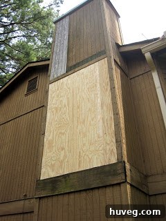 Detailed view of scaffolding set up against a house wall, indicating ongoing exterior work