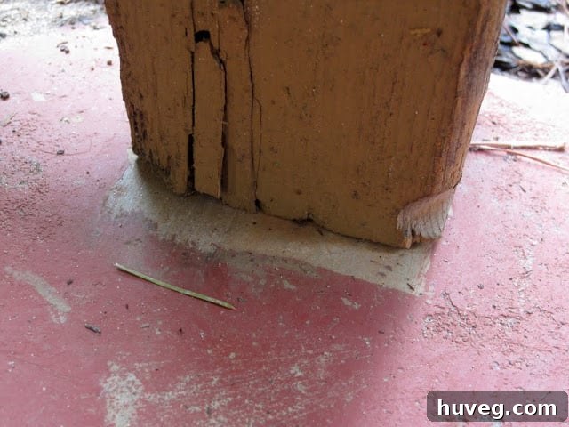 A temporary shim fix for a wobbly porch post.
