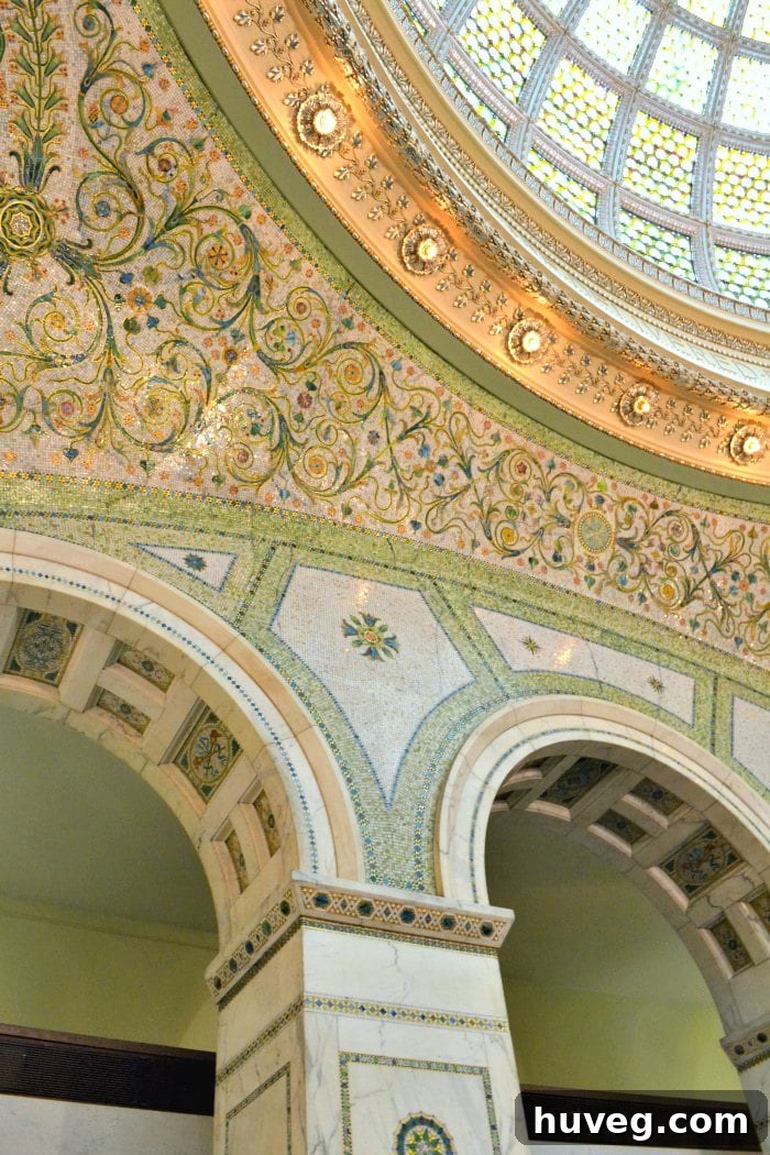 The stunning, ornate interior of the Chicago Cultural Center, featuring elaborate archways, intricate tile work, and rich architectural details.