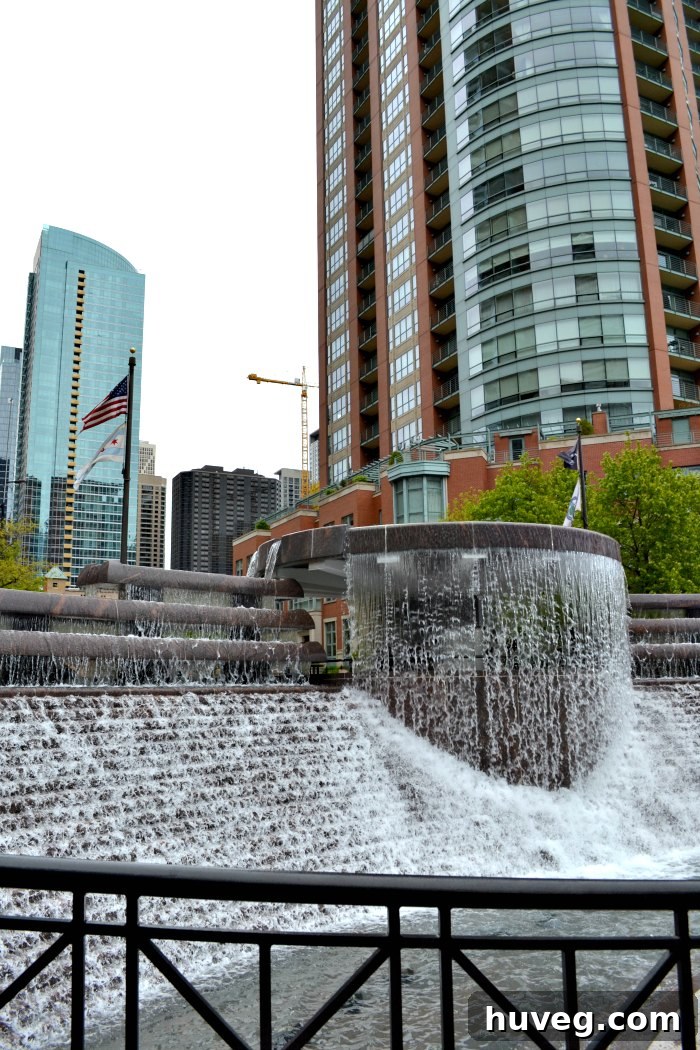 The Nichola J. Melas Centennial Fountain in Chicago, dramatically spraying water high into the air against an urban backdrop.