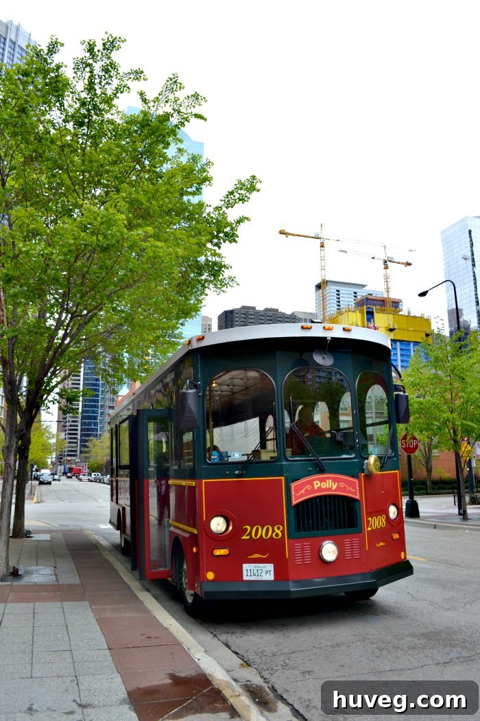 A vibrant red Chicago trolley navigating a city street, surrounded by historic architecture and urban activity.