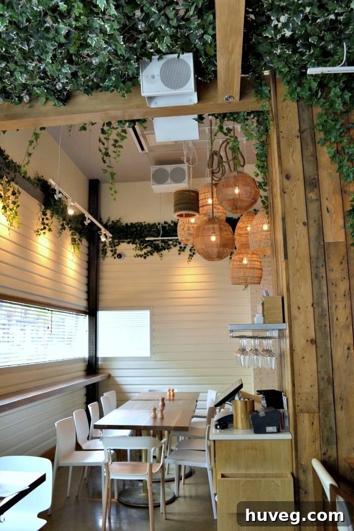 The elegant and brightly lit interior of Ema restaurant in Chicago, showcasing sophisticated dining areas.