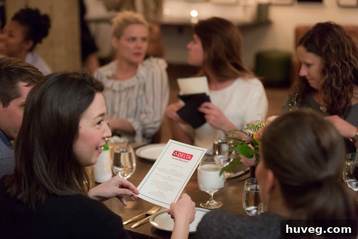 A group of smiling bloggers and Delta Faucet representatives gathered for dinner, enjoying the evening's conversation and food.