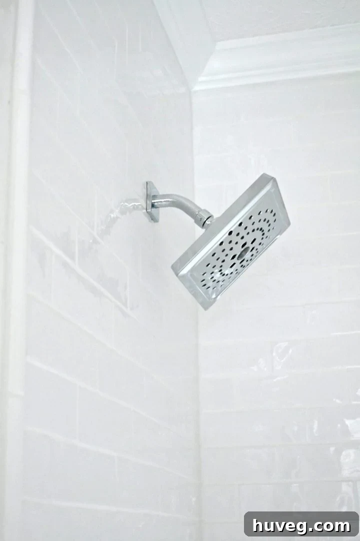 Side view of the Delta Zura bath collection shower head, showcasing its elegant profile