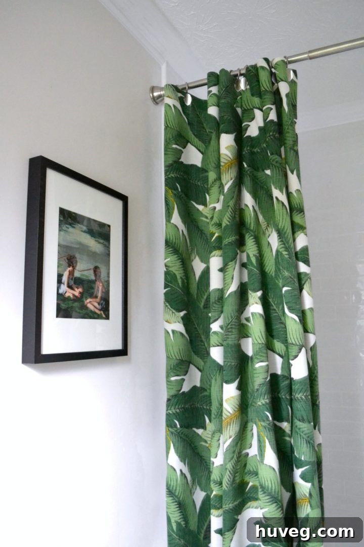 New DIY shower curtain featuring a stylish palm print fabric, adding a pop of color to the bathroom