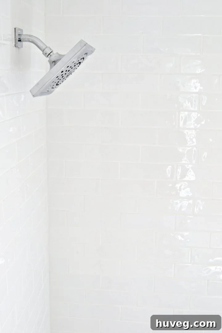 Close-up of the master bathroom shower makeover, highlighting uneven tile surface for movement and light reflection
