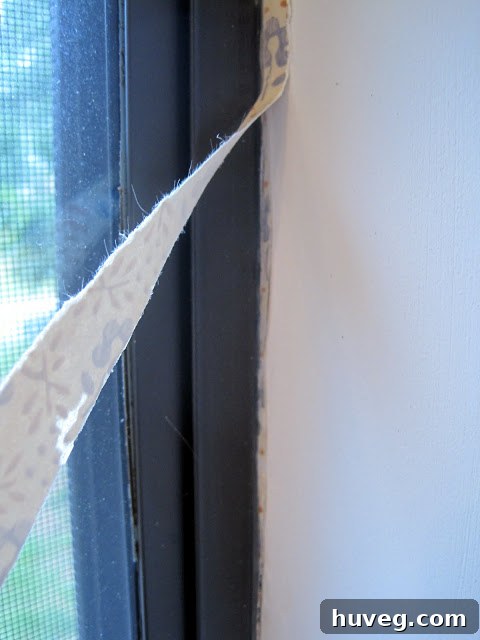 Clean window frame after wallpaper and caulk removal.