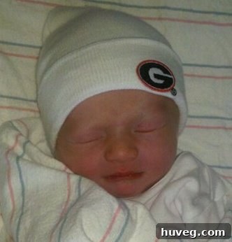 Adorable newborn baby Henry Beau sleeping peacefully, a portrait of innocence and new life.