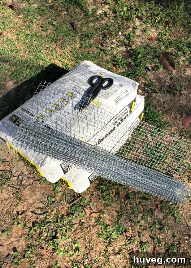 Steel screen, tin snips, and bags of concrete ready for the pour