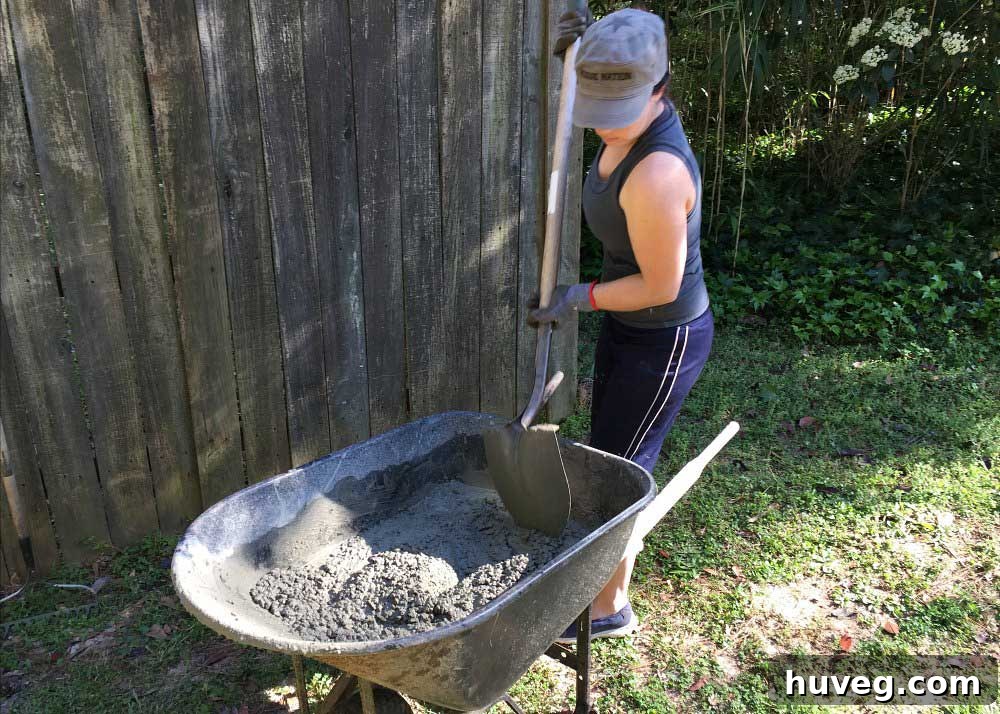 More concrete mixing in a wheelbarrow for the side slab project