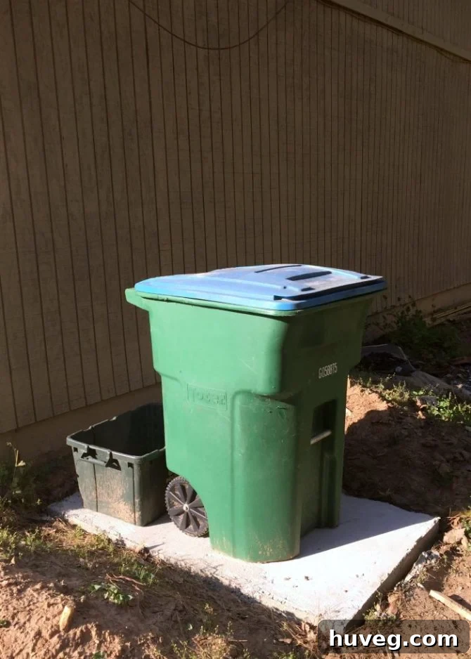 Completed DIY concrete slab for outdoor trash bins