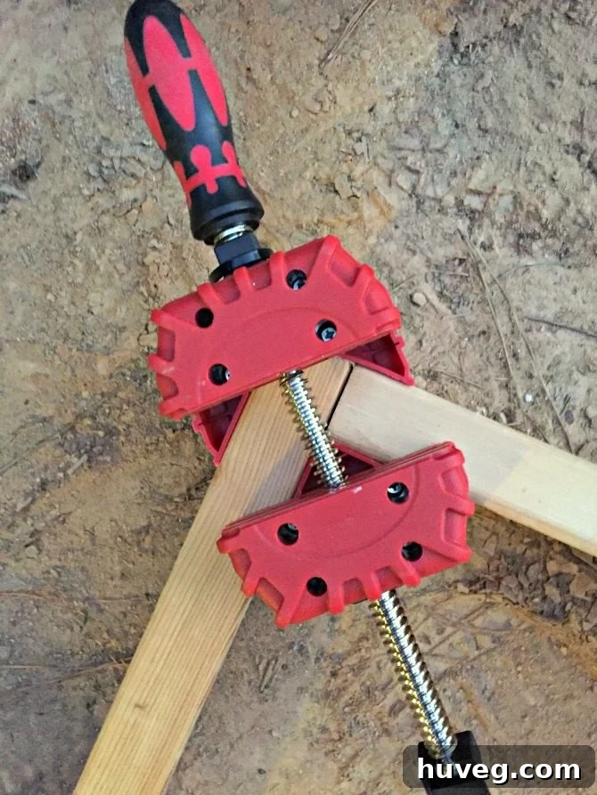 Corner clamp in use on a 2x4 frame for a concrete slab