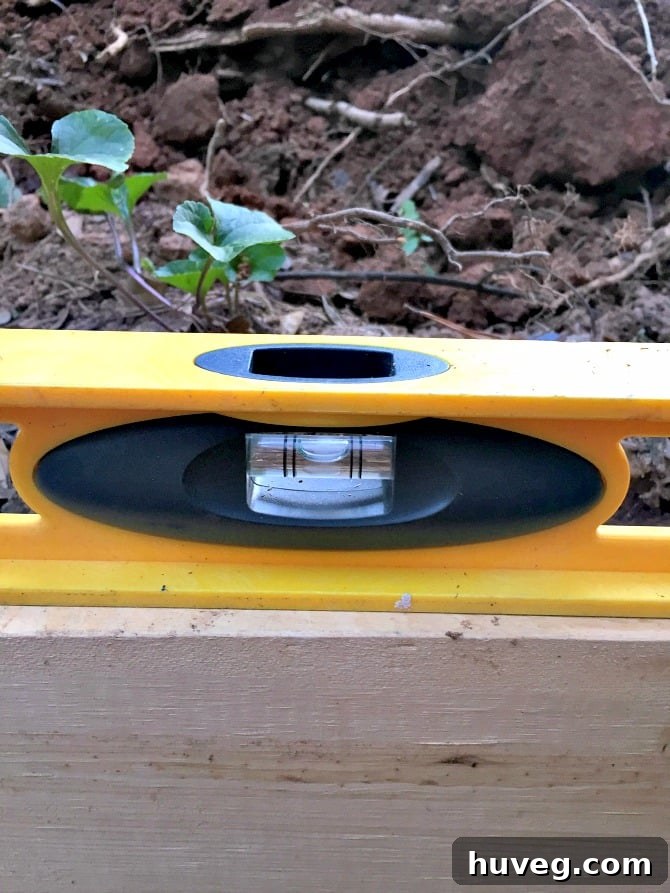 Level measurement on a 2x4 concrete slab frame, showing perfect level when a slight slope was desired