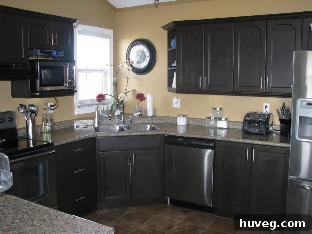 After photo of the beautifully transformed kitchen cabinets with a new dark finish