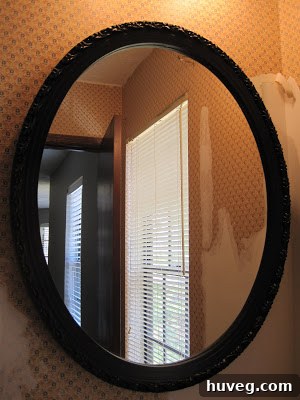 Close-up of the yellow mirror frame, showing the smooth paint finish.