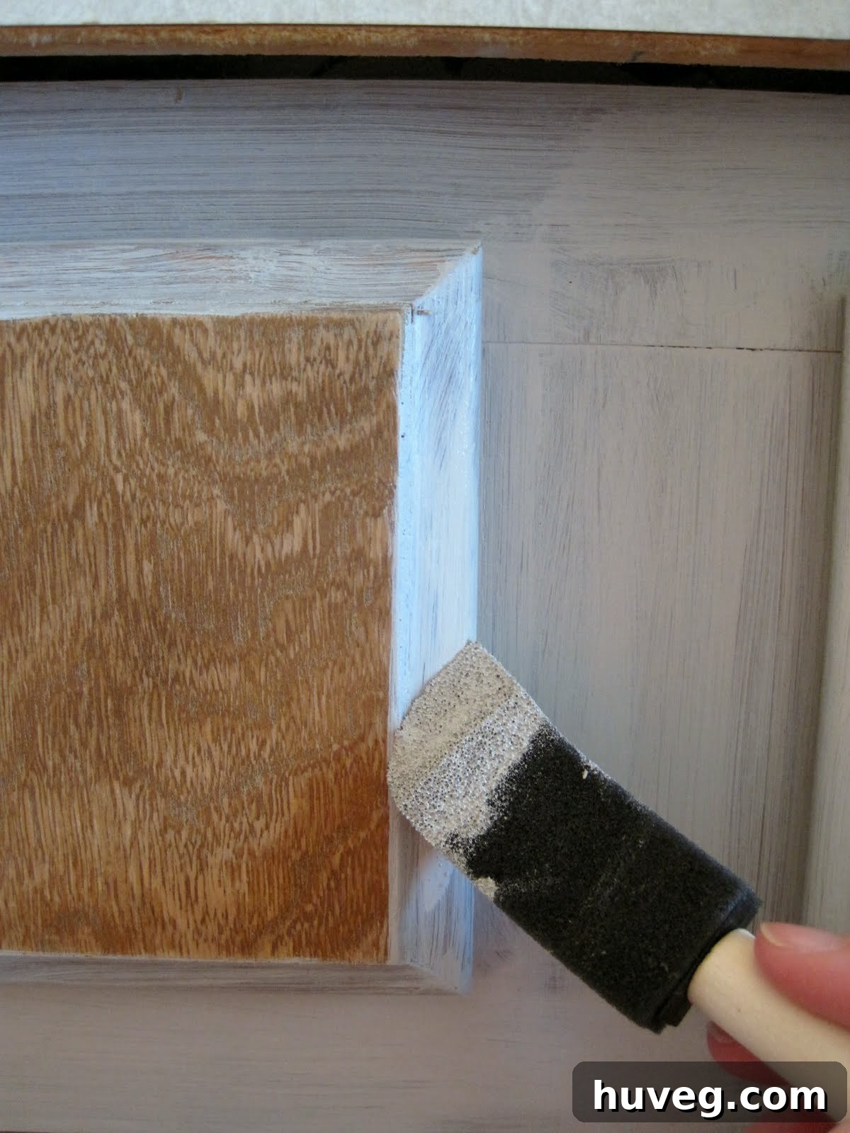 Apply bond coat to cabinet drawers with a foam tool for a smooth finish.