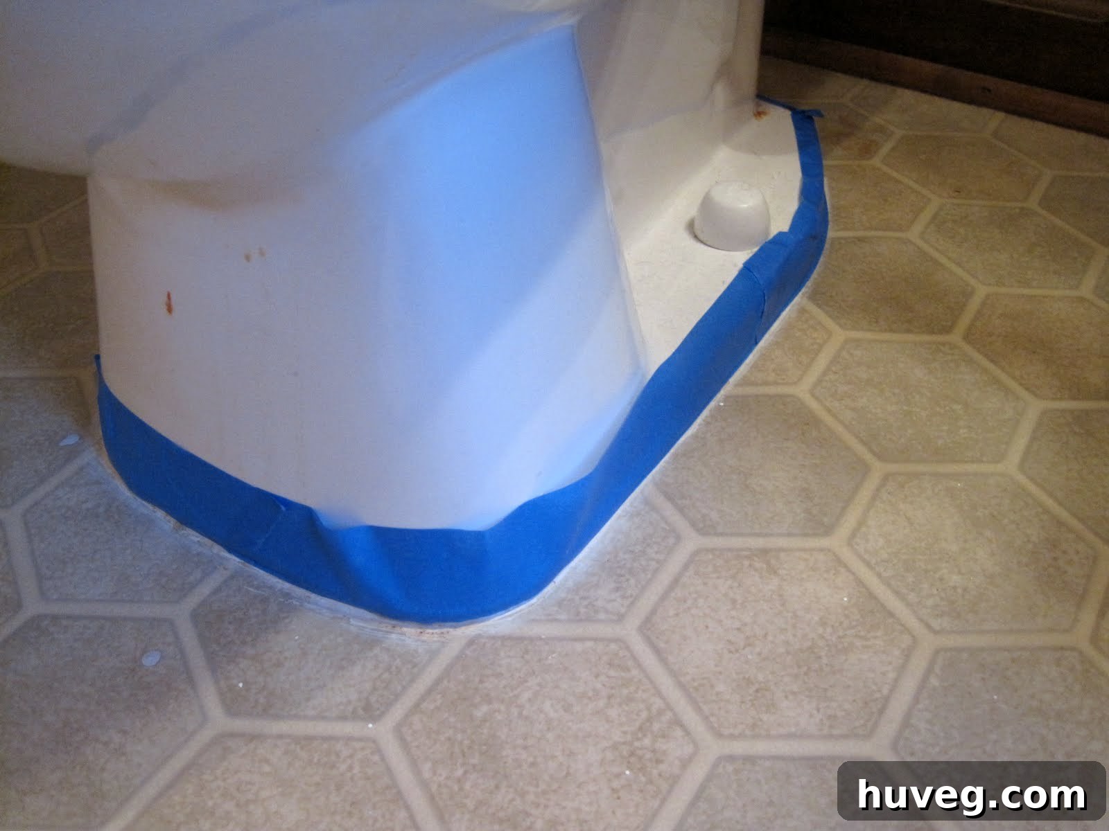 Prepping vinyl floors with painter's tape before painting