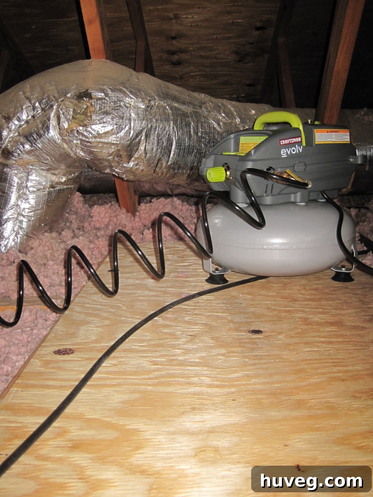 Scott working in the attic, cutting plywood