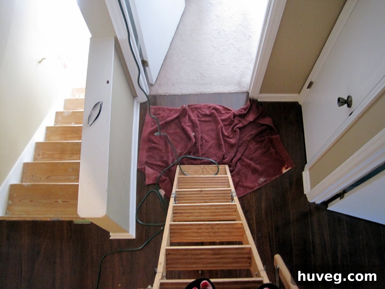 View from below the attic entrance, showing Sarah's perspective