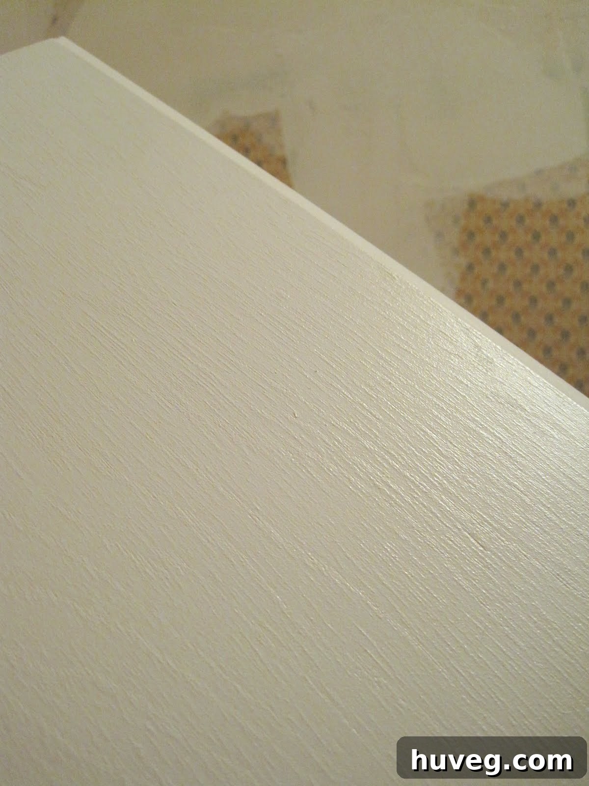 Close-up of painted cabinet surface showing subtle wood grain