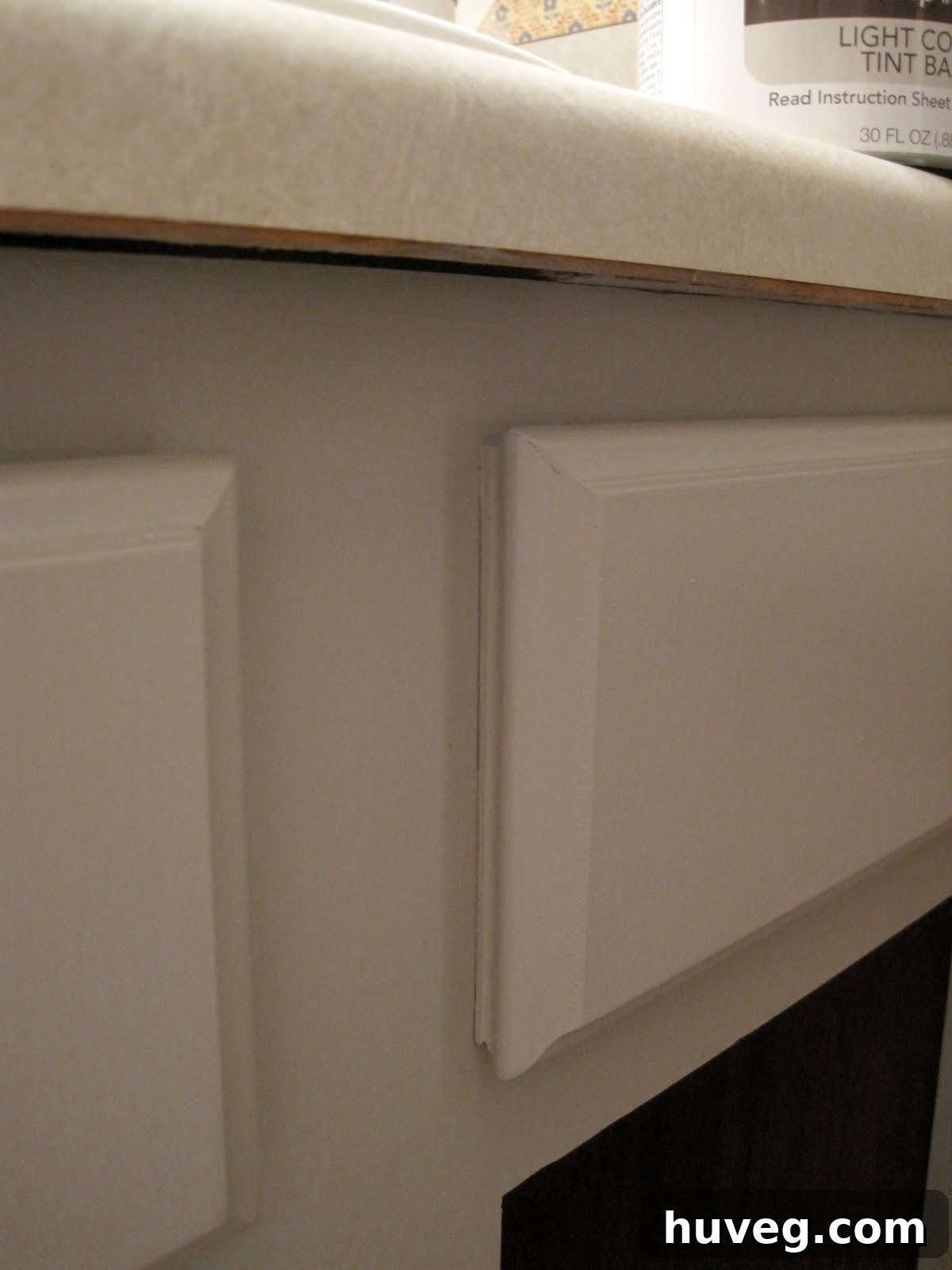 Applying polyurethane with a foam brush to cabinet