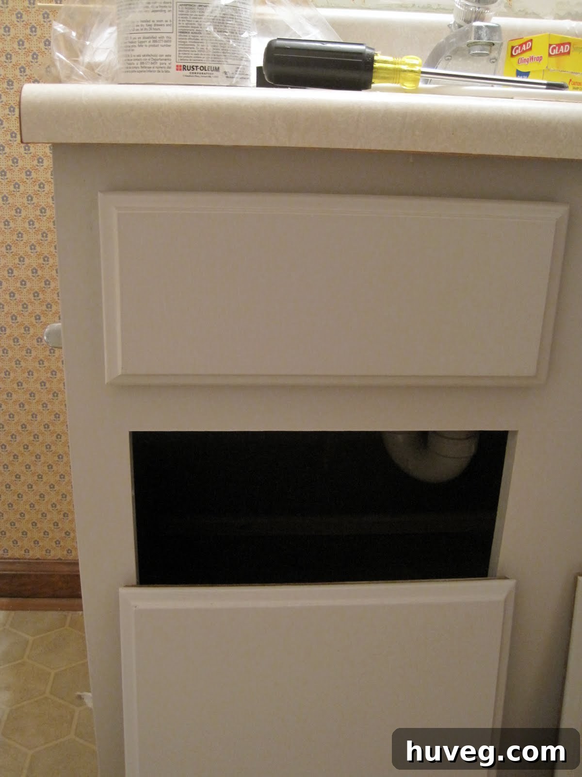 Empty drill holes on cabinet fronts awaiting new pulls