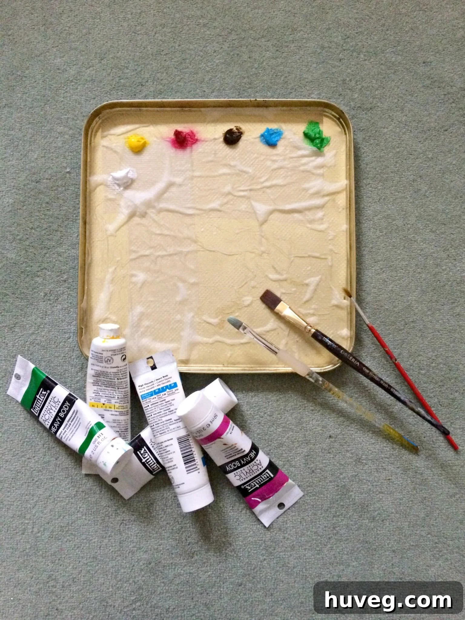 A vibrant artist's palette, organized color by color with acrylic paints, showcasing a range of mixed shades ready for mural application.