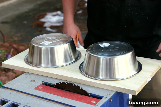 Flipped stainless steel dog bowls positioned on wood plank