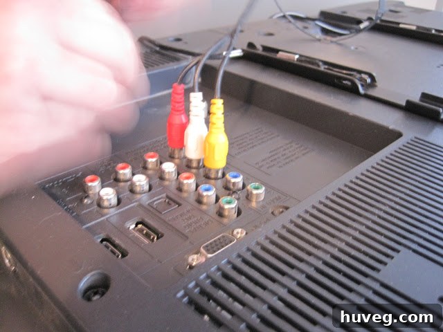 Plugging auxiliary cables into the back of the TV