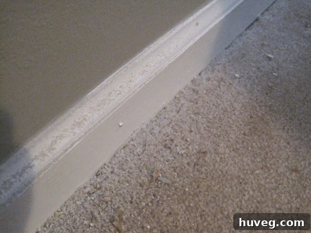 Drywall dust on baseboards after cutting, indicating cleanup is needed