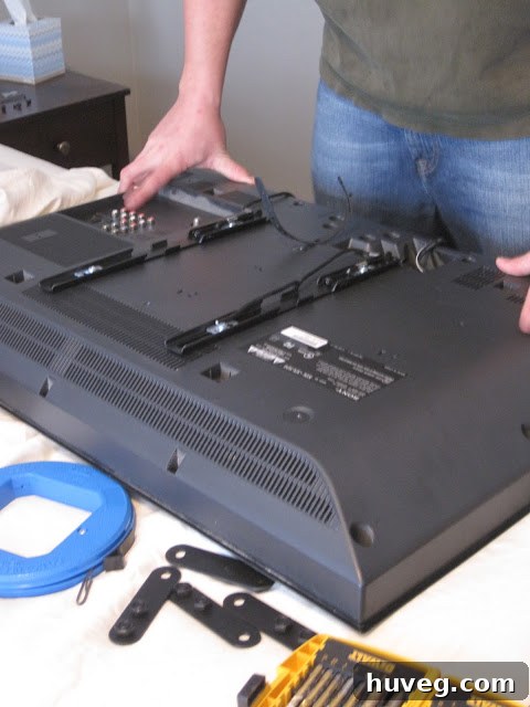 Mounting brackets being attached to the back of the TV
