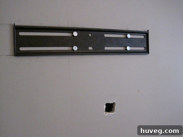 Wall mount installed and a marked hole for wires beneath it