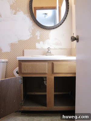 The old, dark wood vanity in the primary bathroom, awaiting its makeover.