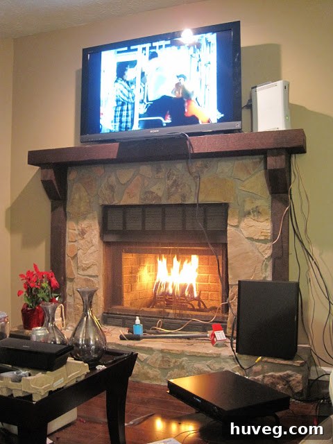 A cozy scene with a burning fireplace and decorative elements.