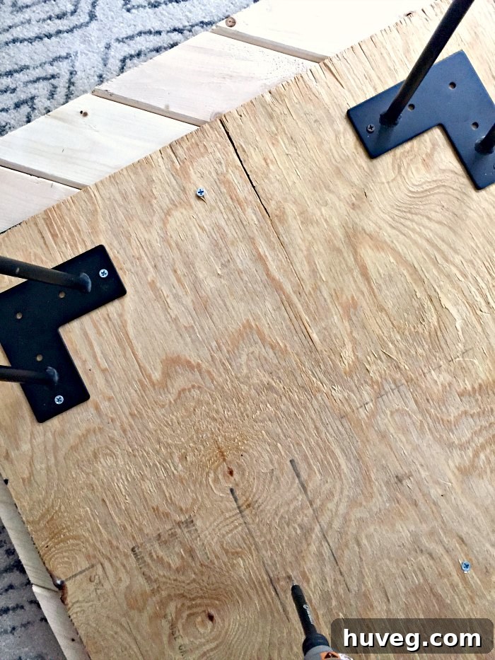 Underside view of the coffee table, showing the plywood base and attached 2x4 pieces before legs are added.