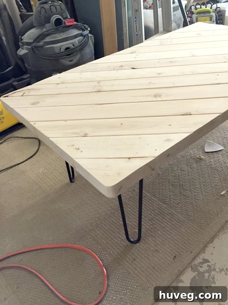 Coffee table prepped for finishing in the garage, showcasing its solid construction.