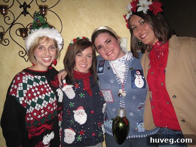 The author proudly displaying her chosen tacky Christmas sweater, embellished with festive details, and her custom-made pom-pom headband.