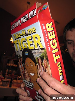 A close-up shot of a humorous and slightly scandalous White Elephant gift, wrapped and then revealed, eliciting surprised reactions.