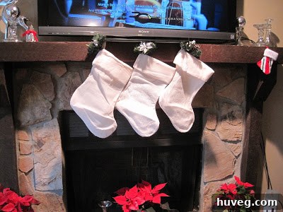 Two dollar store Christmas stockings hanging, appearing somewhat cheap.