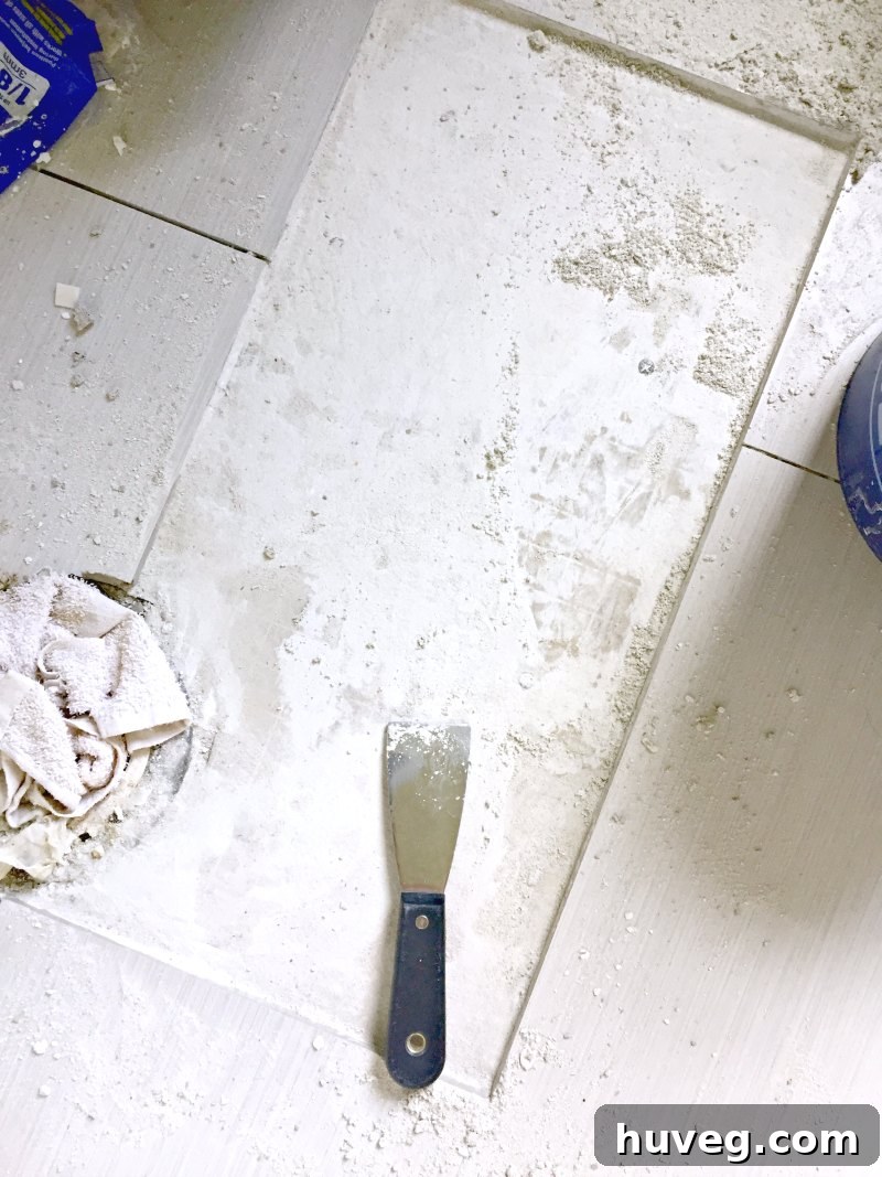 Bathroom floor with dried tile adhesive after initial removal